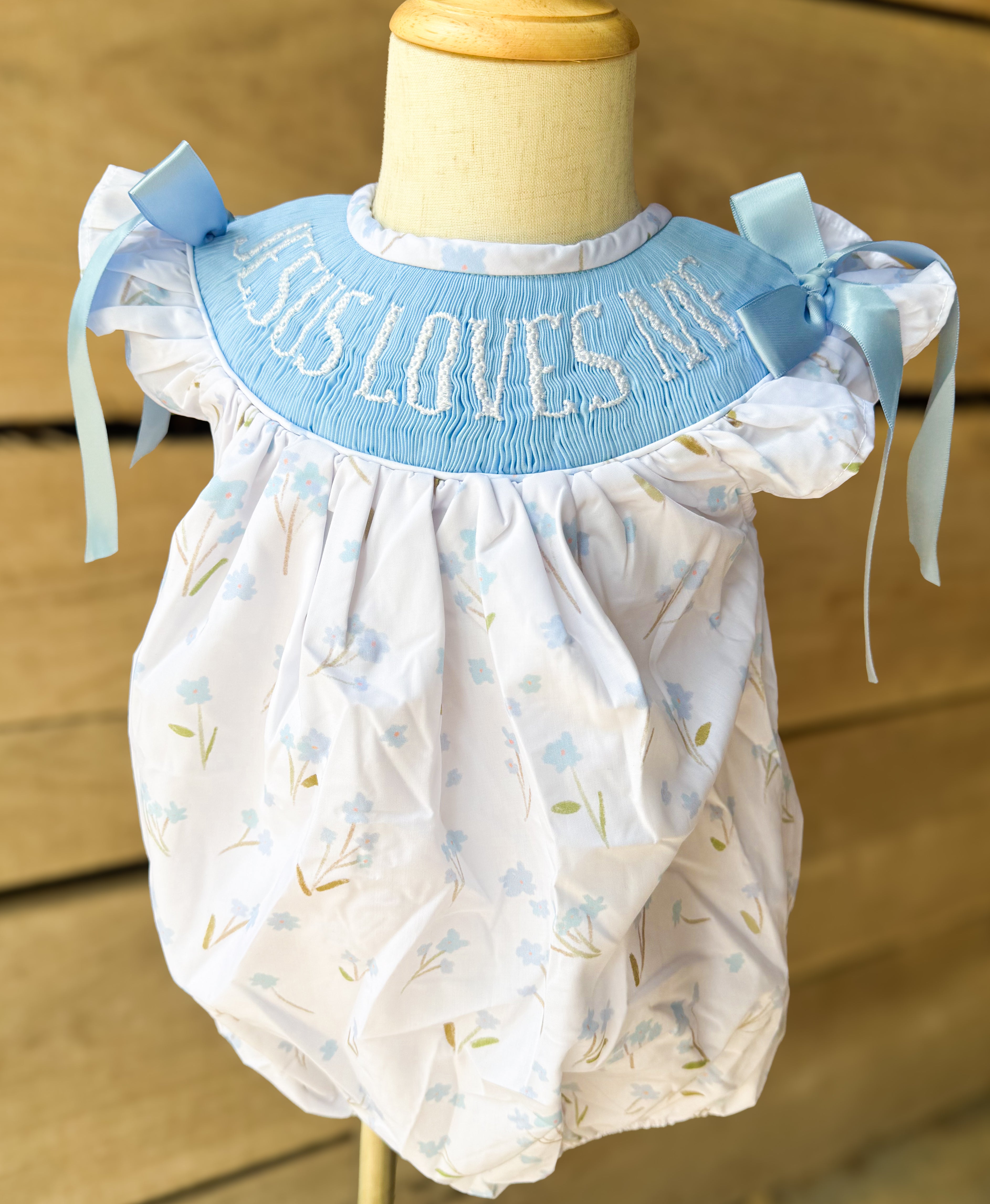 Girls “Jesus Loves Me” Smocked Blue Meadow Bubble